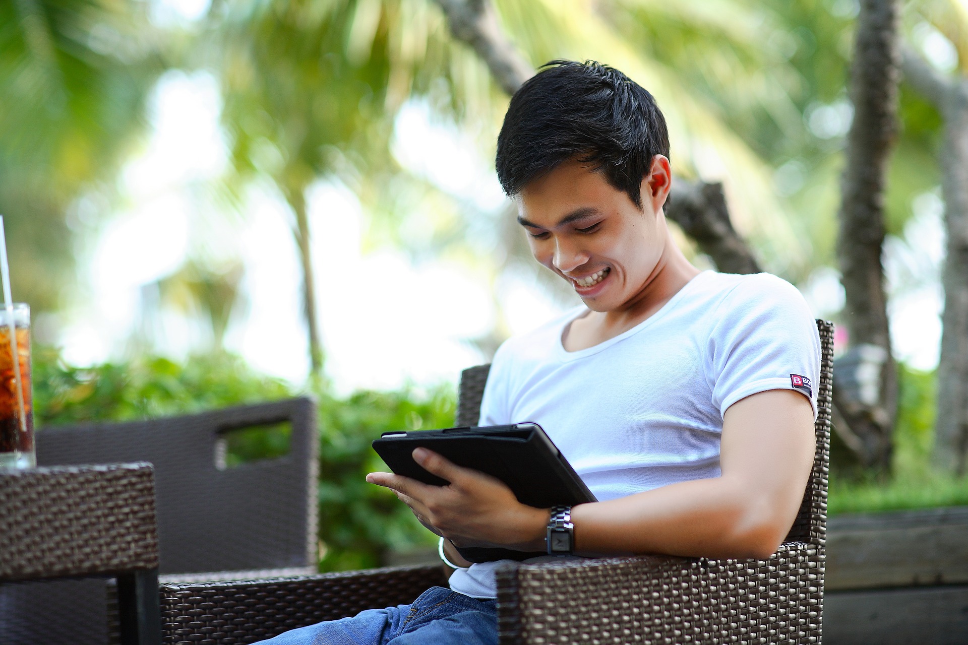 man smiling while on tablet computer online marketing agency Tampa